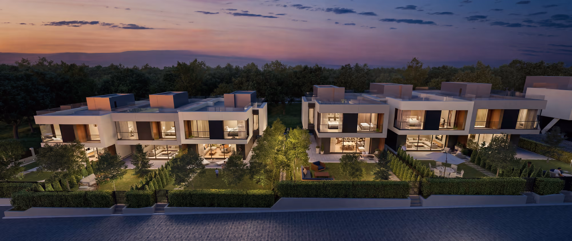 Illuminated townhouses and private gardens at dusk