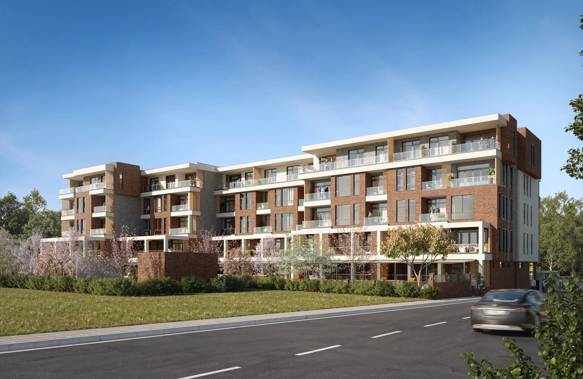Wide view of the residential building and landscaped grounds from the street